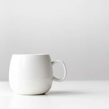 White mug on a table by nordwood themes