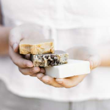 Woman holding handmade soaps by sincerely media