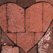 Loveheart brick in paving by tim mossholder